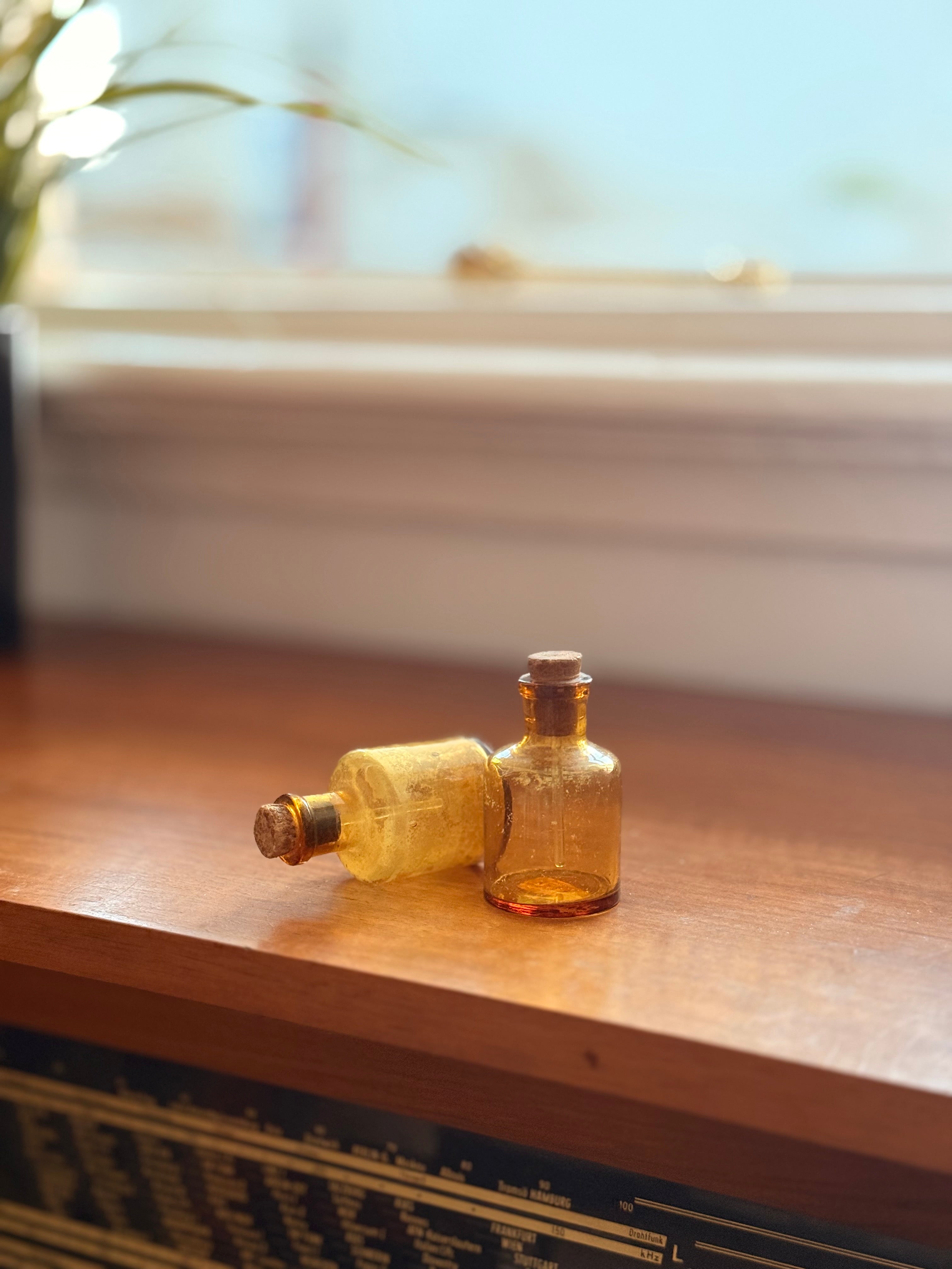 Pair of amber glass dropper jars, 1940s–60s