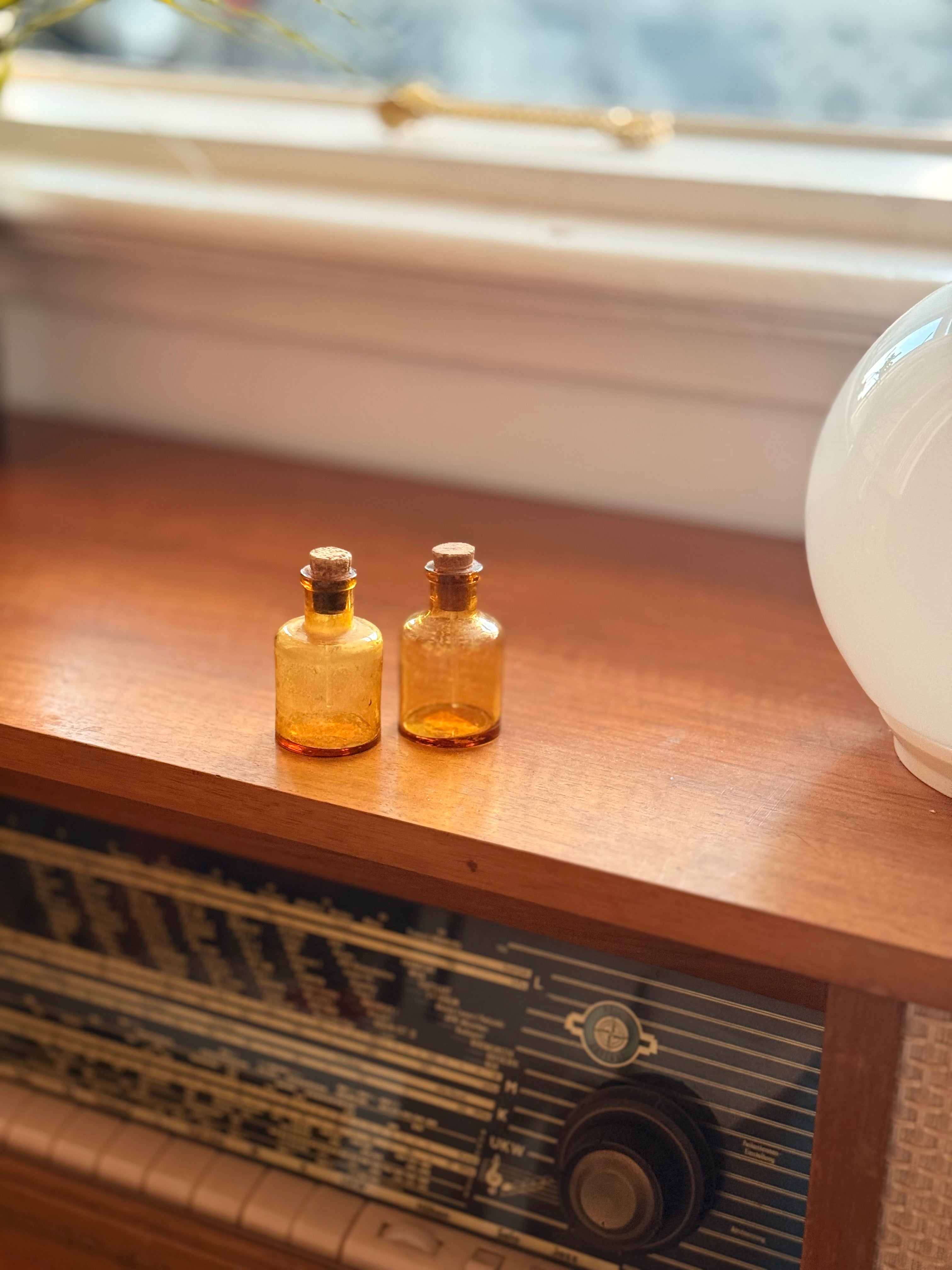Pair of amber glass dropper jars, 1940s–60s