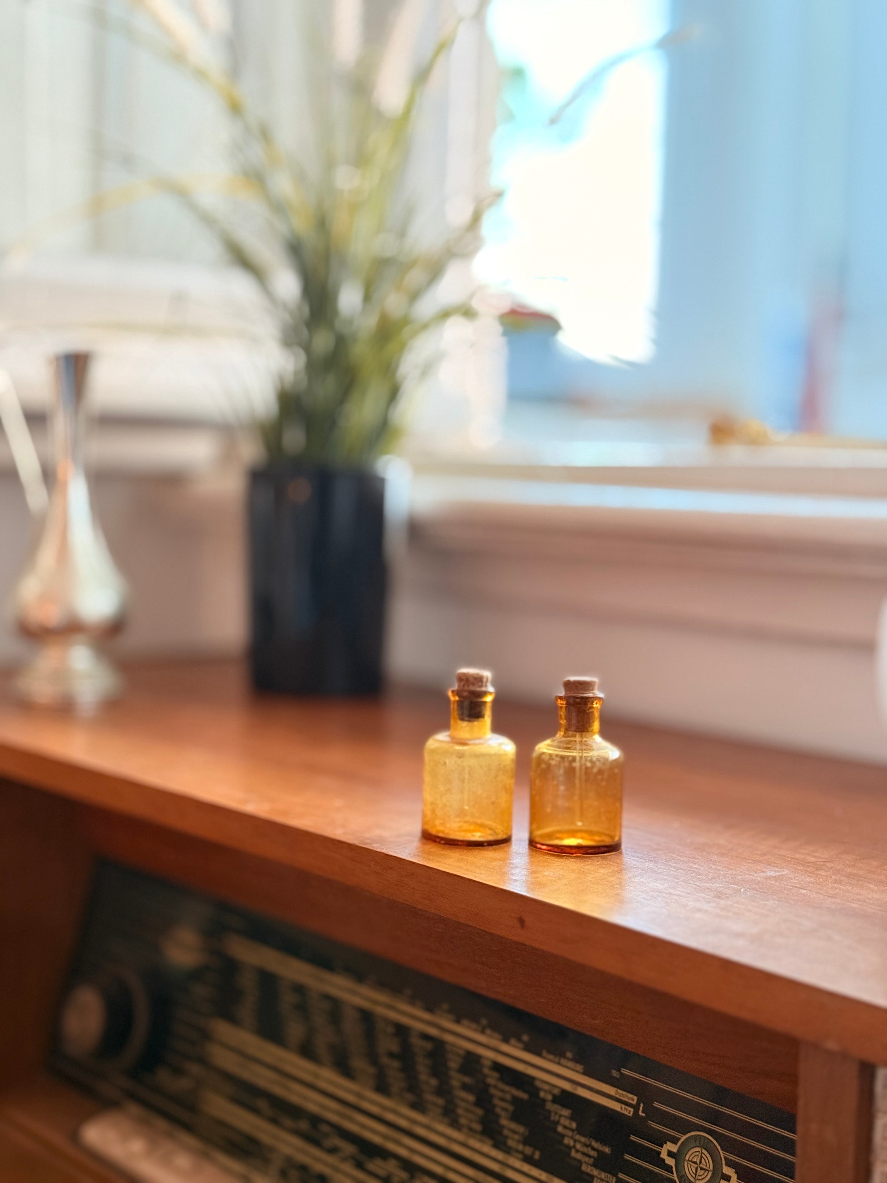 Pair of amber glass dropper jars, 1940s–60s