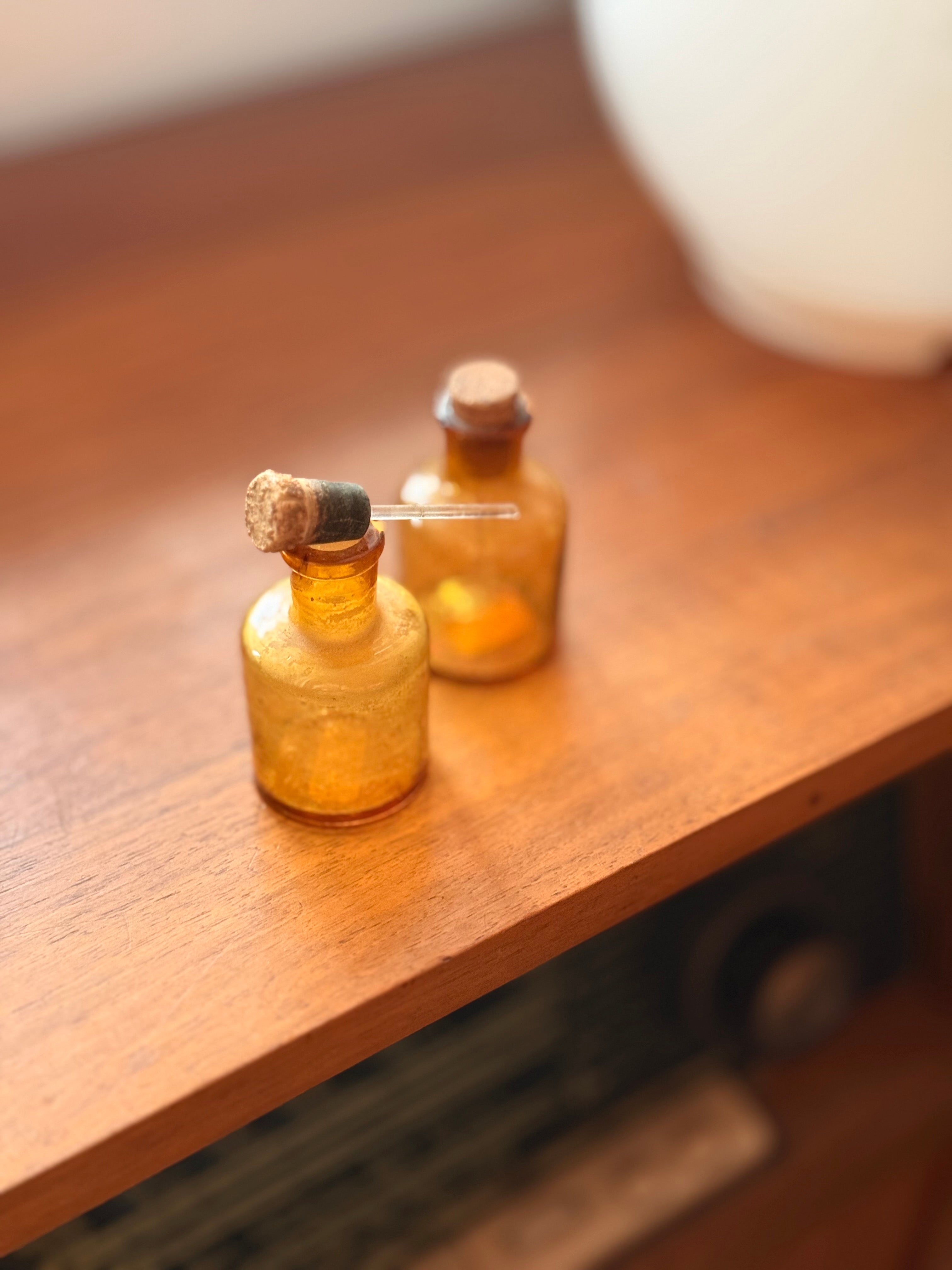 Pair of amber glass dropper jars, 1940s–60s