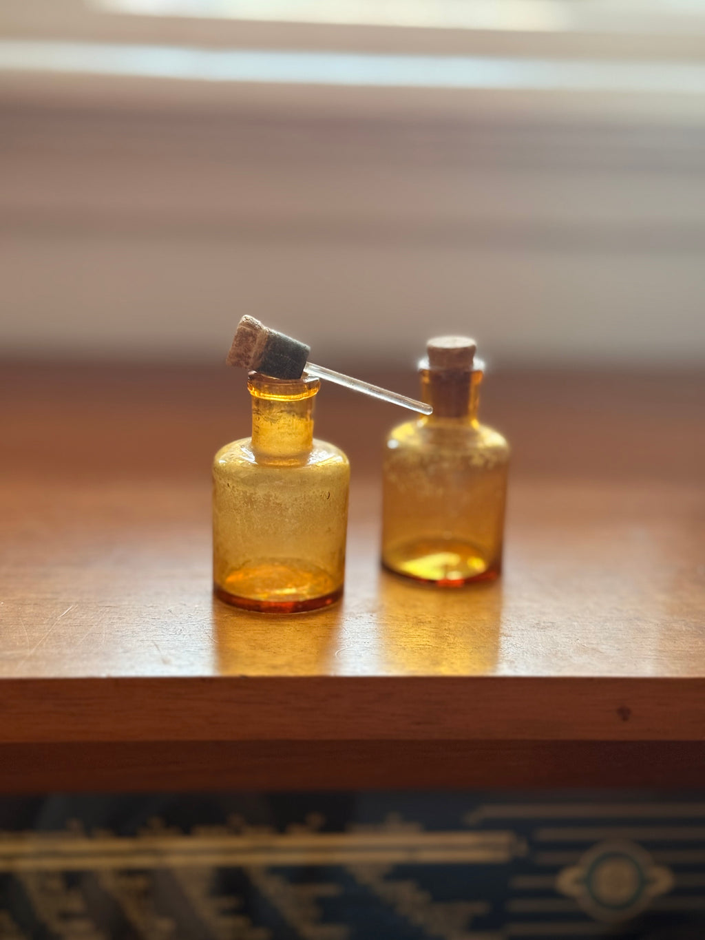 Pair of amber glass dropper jars, 1940s–60s